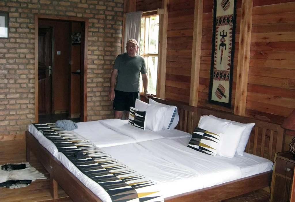 Comfortable twin room with wooden interiors representing mid-range accommodation in Ruhija near Bwindi Impenetrable National Park, Uganda