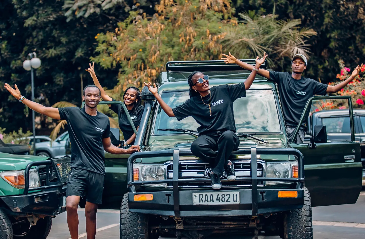 Tavira Africa Safaris team beside a safari vehicle